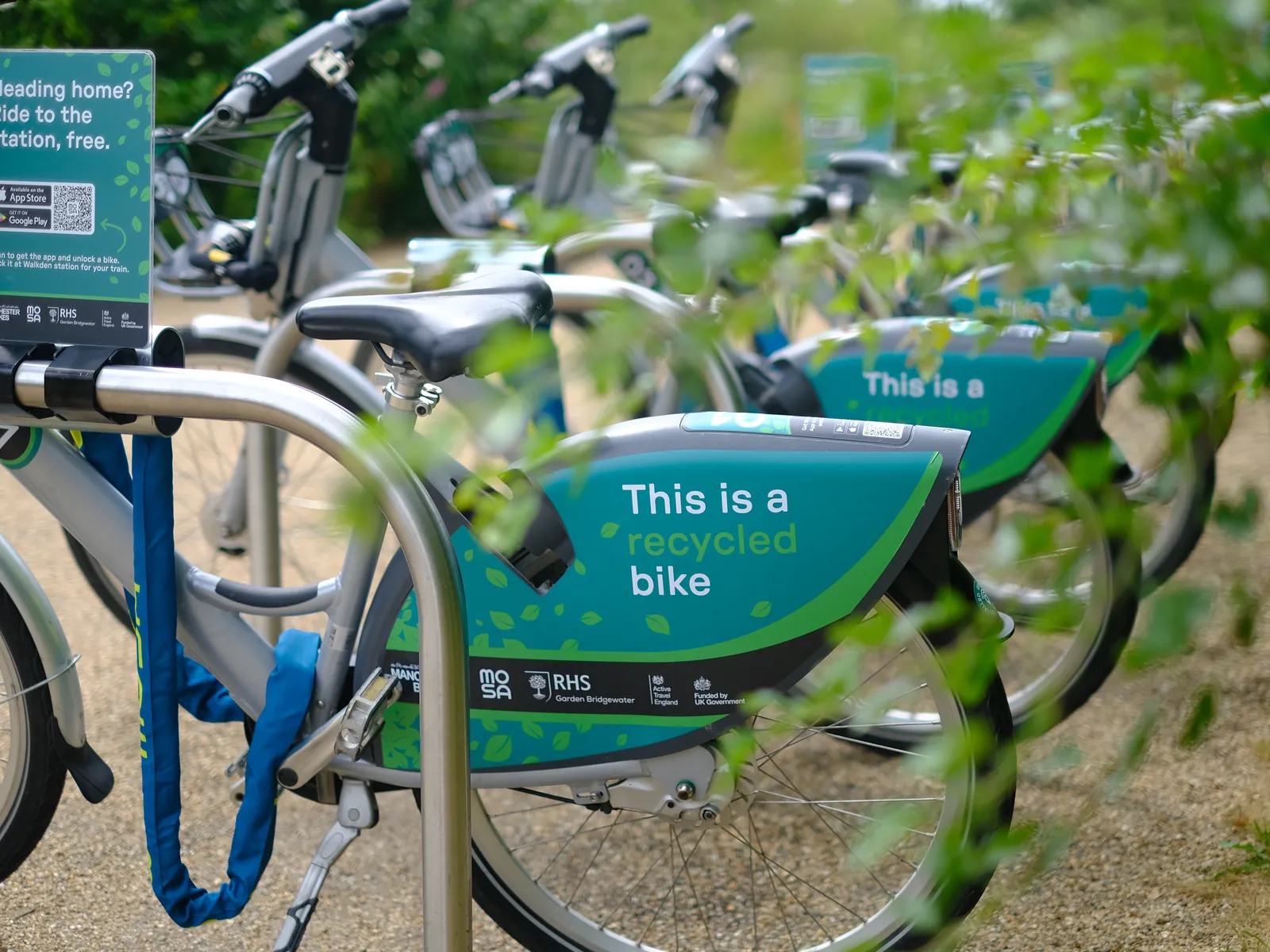 A recycled shared bike locked into a dock on a steel rack at RHS Bridgewater.