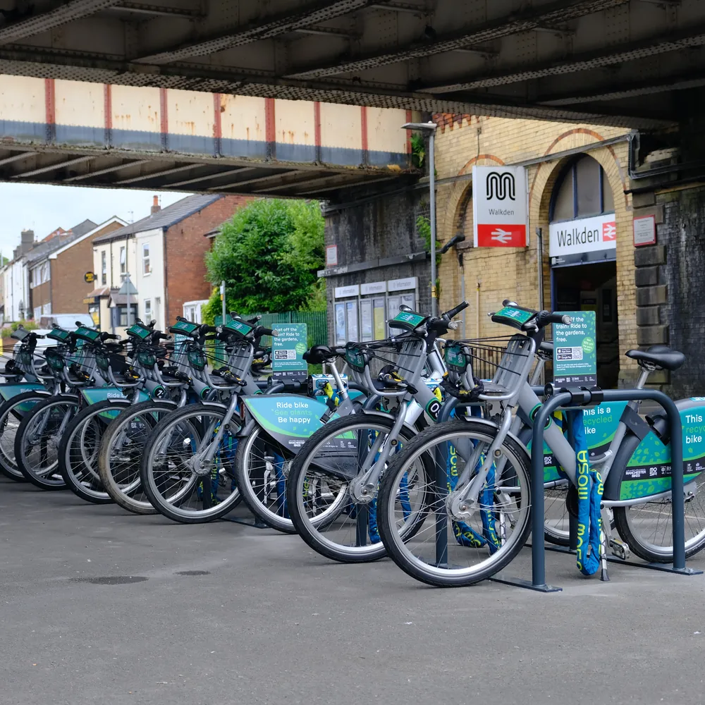 RHS Bridgewater shared bikes docked under the railway bridge at Walkden station.