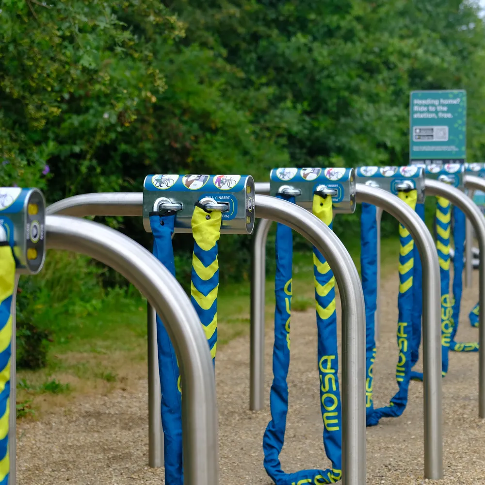 A long row of Mosa docks on steel racks along the path at RHS Bridgewater.